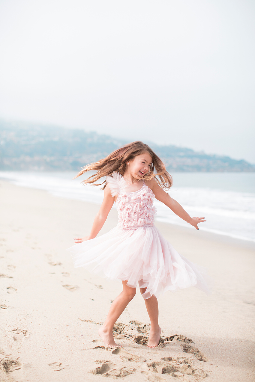 Manhattan Beach Photographer- girl twirling at the beach