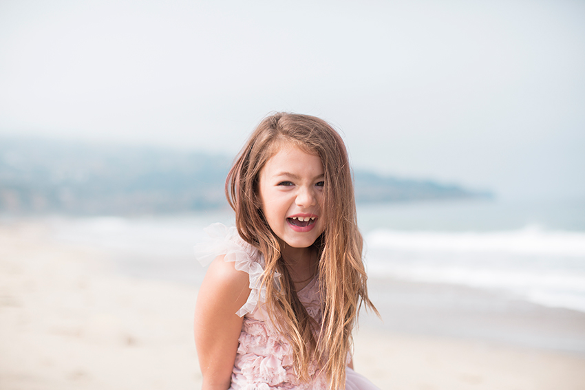 Manhattan Beach Photographer- girl laughing at the beach